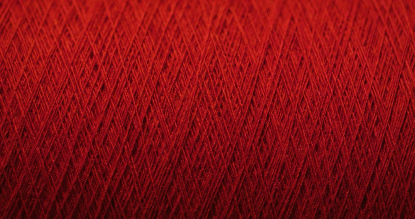 Close-up of red thread wound on a cone